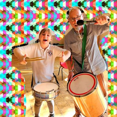 a pupil and the musician with their samba drums